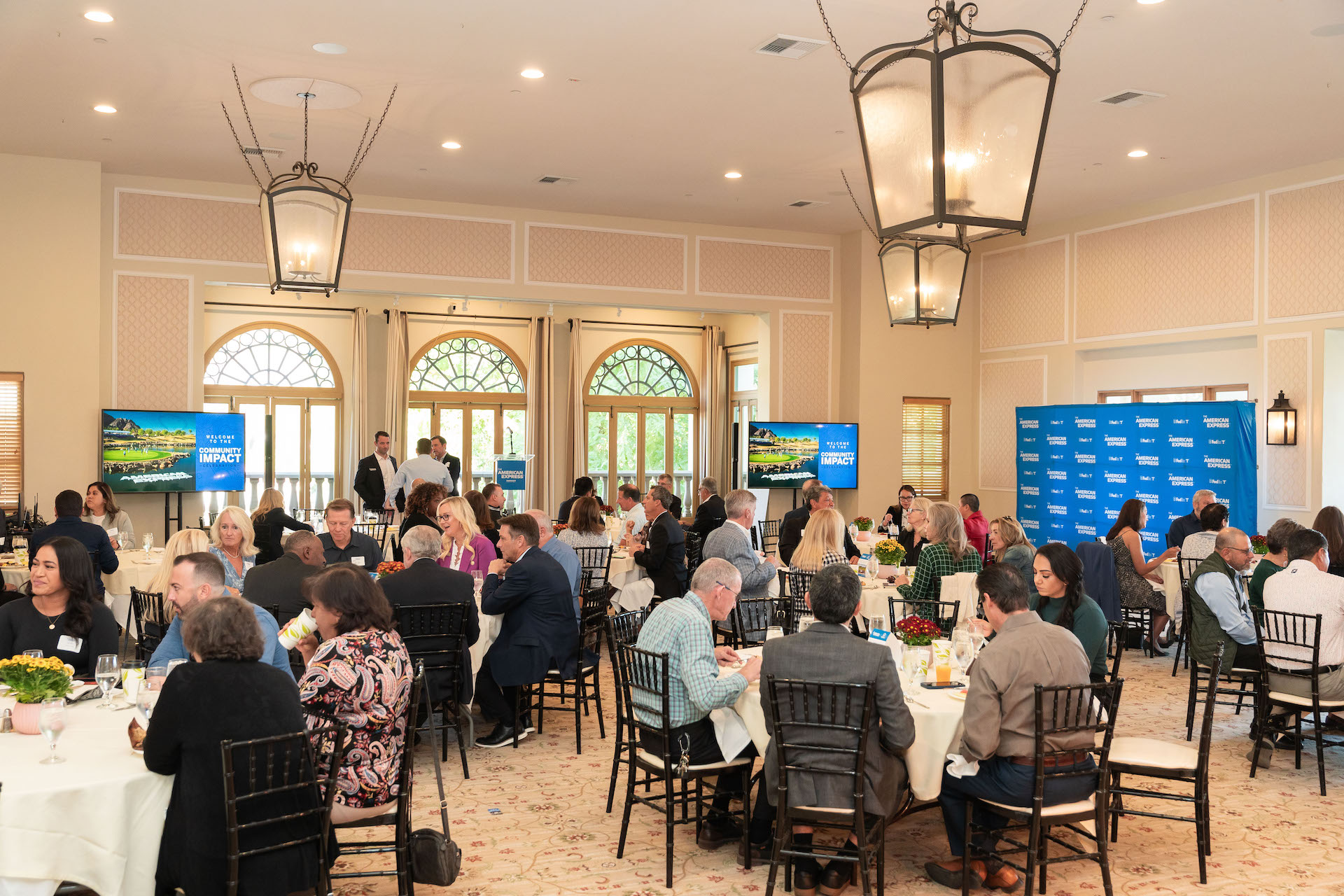 AMEX_Breakfast_2023_30 people standing behind charity check and smiling